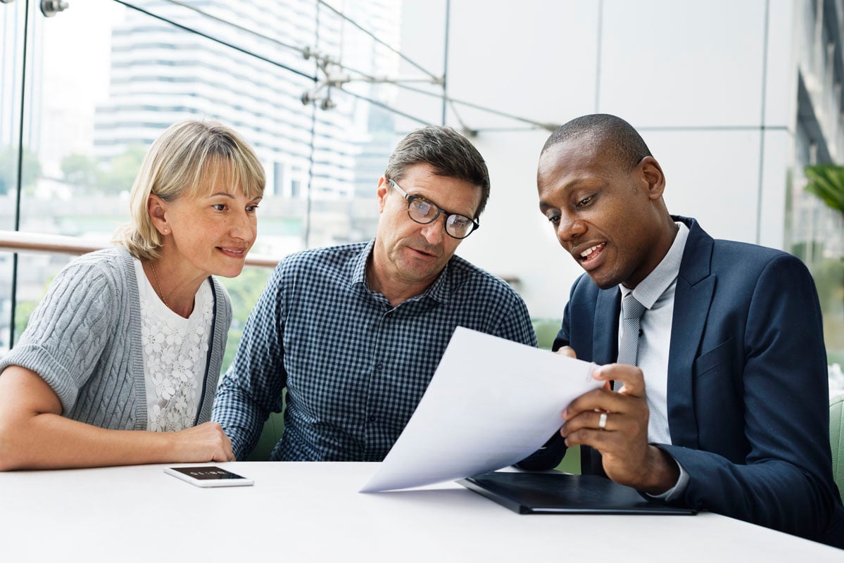 couple-reviewing-paperwork-with-rep